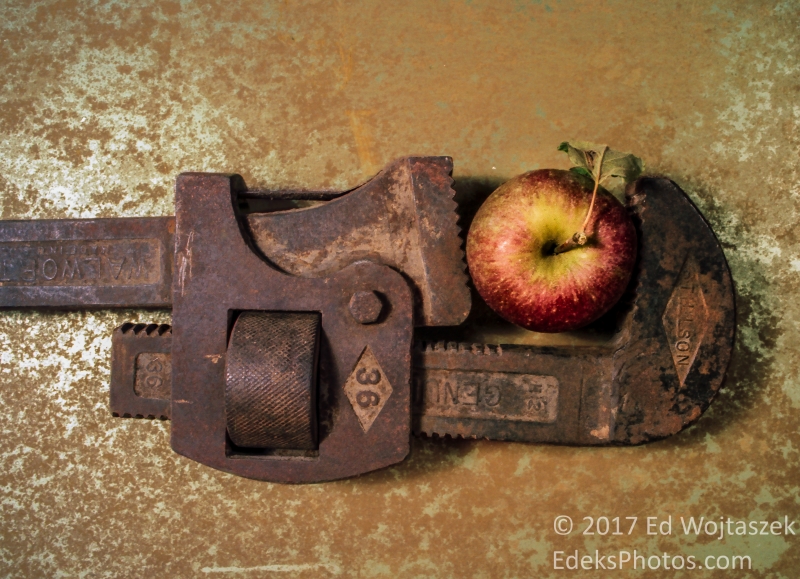 Pipe Wrench Holding an Apple